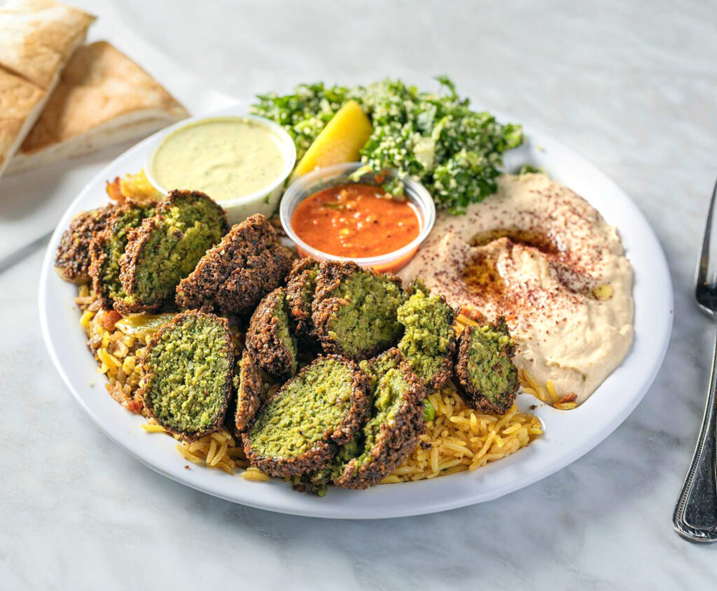 Vegan Falafel Dinner from Sultan’s Market. 3 pieces of crispy falafel served with rice, hummus, tabuli, tahini sauce and a warm pita.