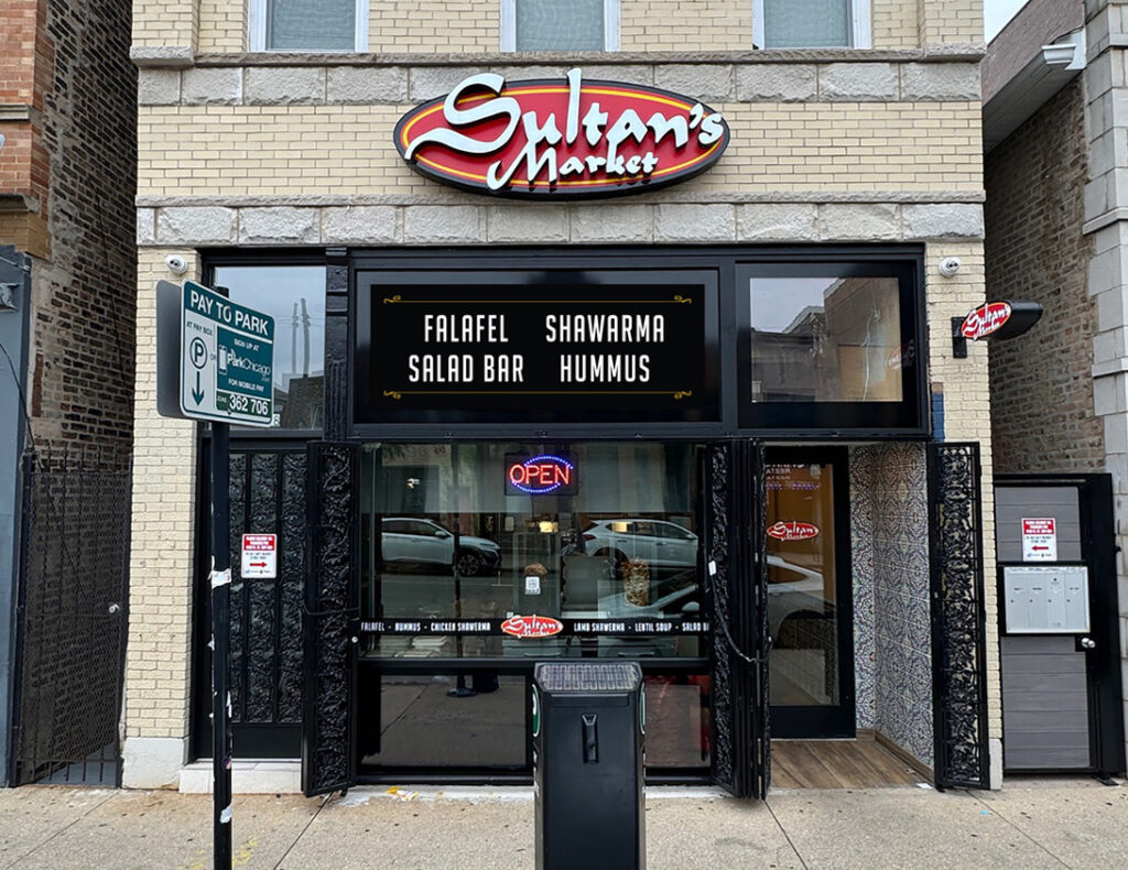 Exterior view of Sultan's Market located in Chicago’s Pilsen neighborhood, featuring Middle Eastern-inspired design, street-facing windows, and welcoming signage.