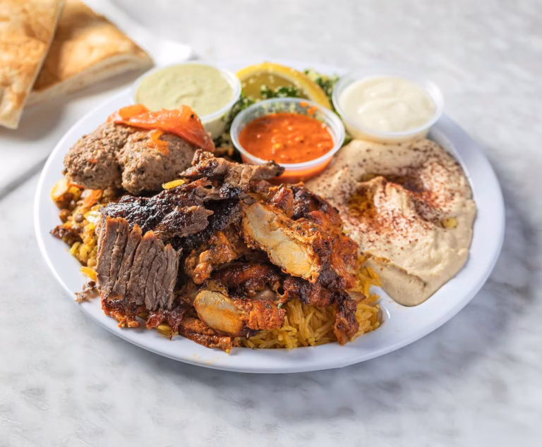 Sultan’s Market Pilsen Meat Combo: An authentic Middle Eastern feast with chicken and lamb shawarma, kefta, and hummus—the ideal pre-show dinner near Thalia Hall.